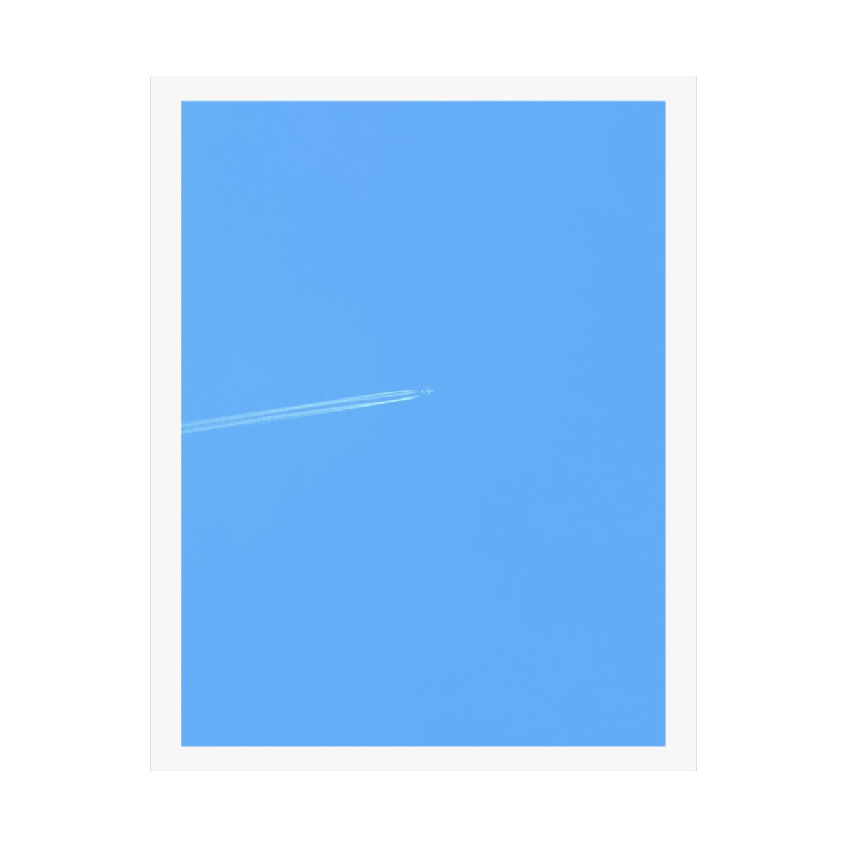 Print of a photograph of pale blue sky crossed by a single faint aeroplane contrail.