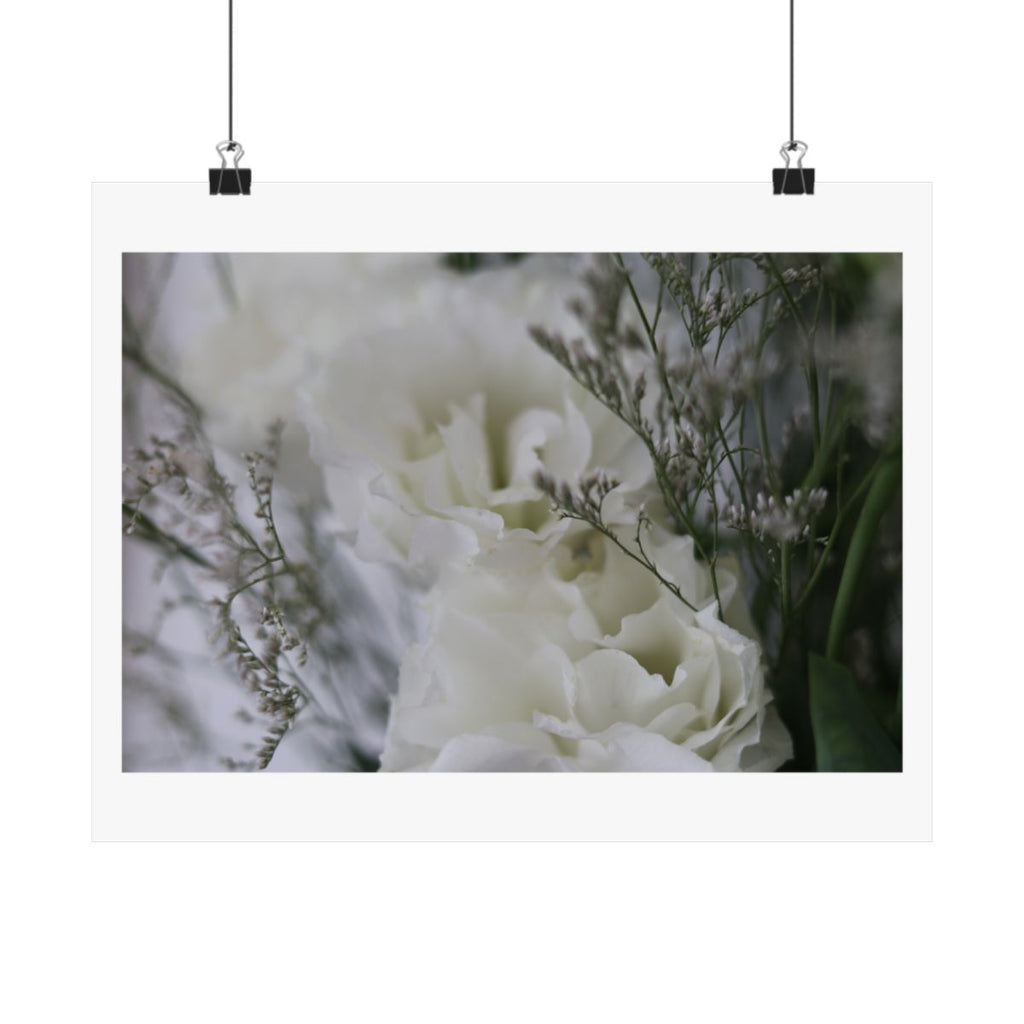 Print of a photograph of white lisianthus among tall seed heads and grasses, shown hanging from binder clips.