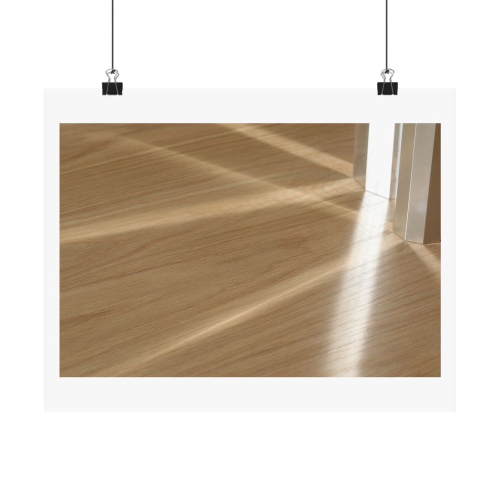 Print of a photograph of morning light falling in bands across a pale wood floor, shown hanging from binder clips.