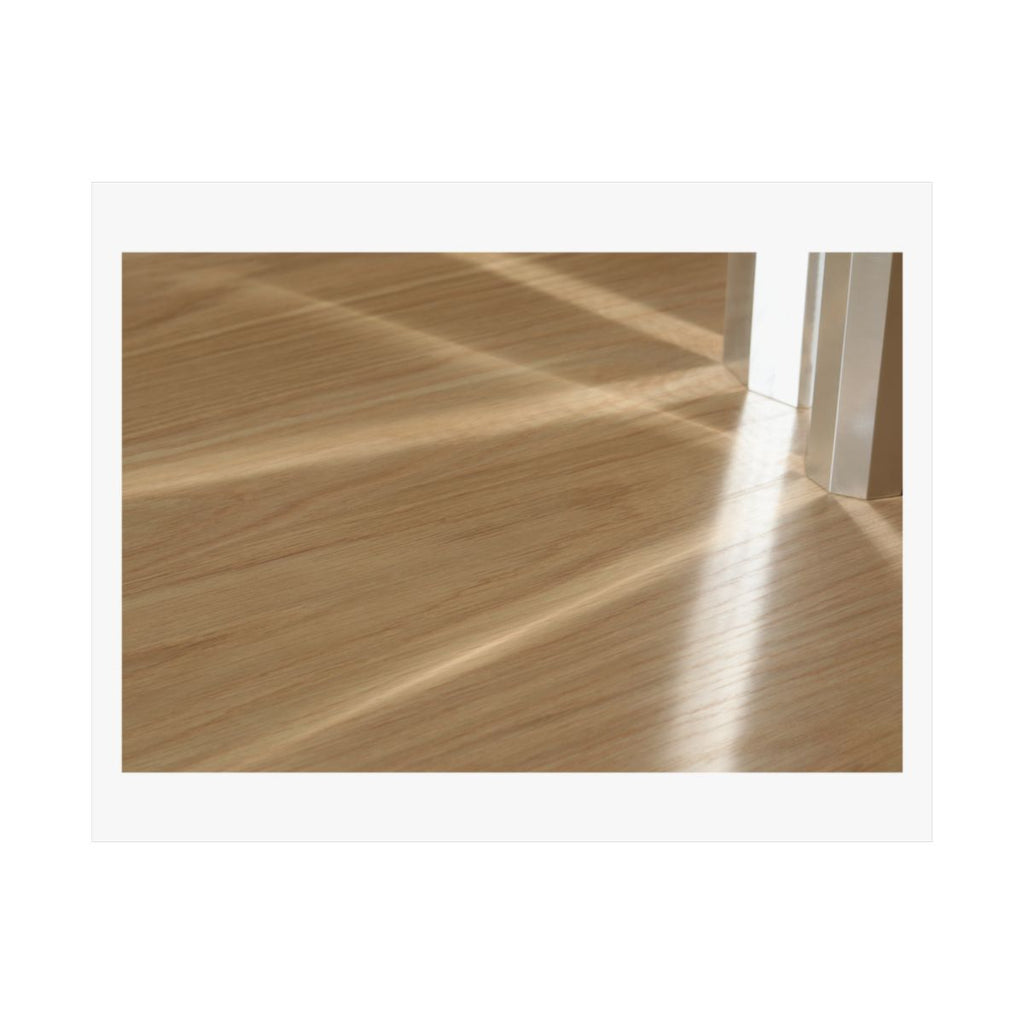 Print of a photograph of morning light falling in bands across a pale wood floor.