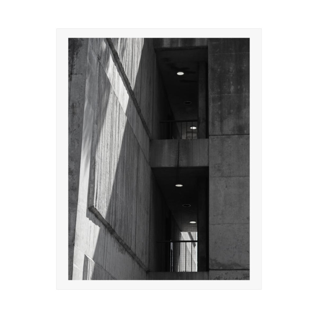 Print of a black and white photograph looking up a concrete stairwell.